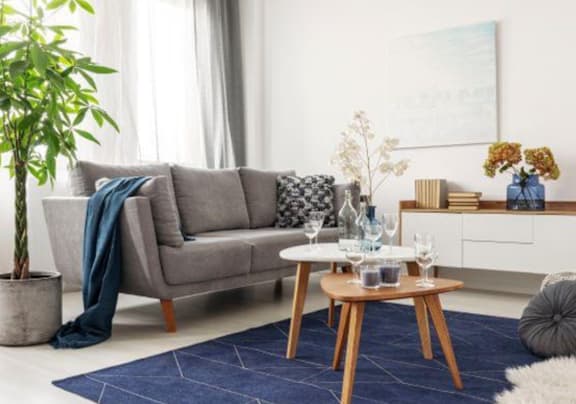a living room filled with furniture and a large window