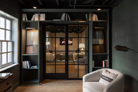 a living room with a chair and a glass door