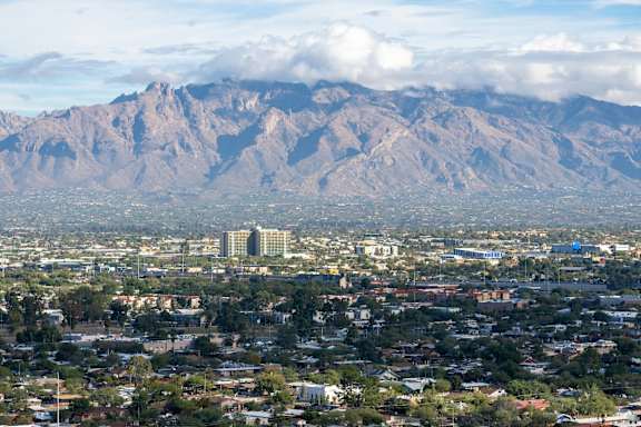A cityscape with a mountain range in the background.