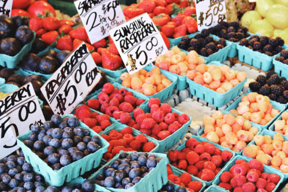 a fruit stand at a farmers market with blueberries and raspberries for sale at Palm Crossing, Florida, 34787