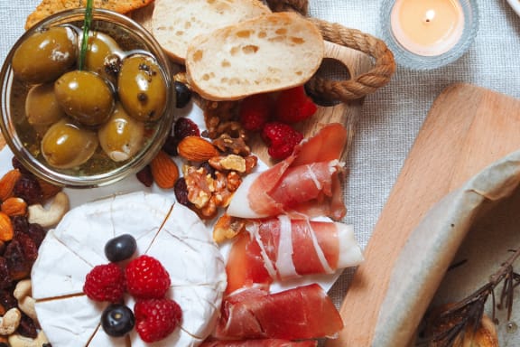 a cheese board with prosciutto ham olives and bread at Palm Crossing, Florida, 34787