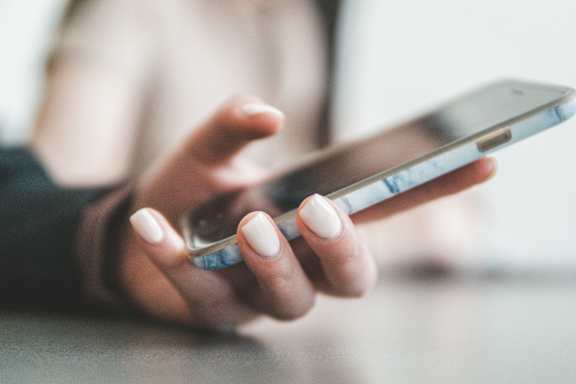 A person is holding a smartphone in their hand.