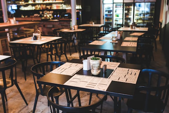 A restaurant with tables and chairs set up for dining.