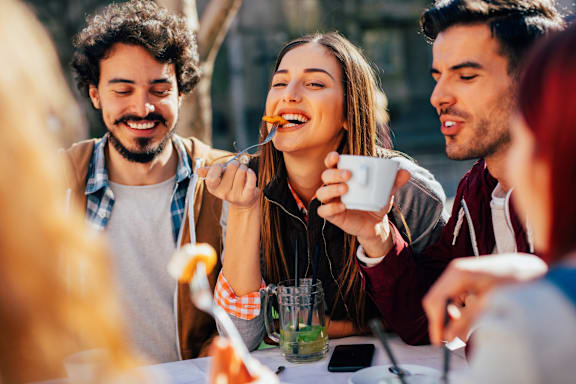 A group of people enjoying a meal together outdoors.