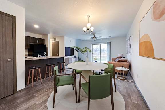 A spacious living room with a staircase leading to the upper floor.