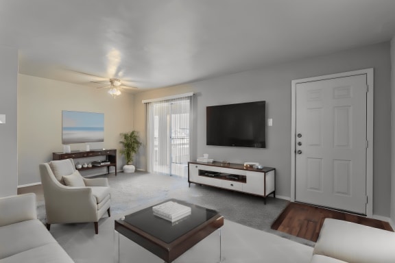 a living room with a white couch and a television