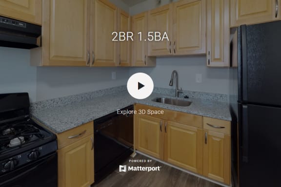 a kitchen with white granite countertops and black appliances at Courthouse Green Apartments, Chesterfield