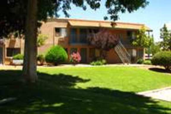 A house with a green lawn in front.