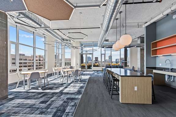 A modern office space with a long table and chairs.