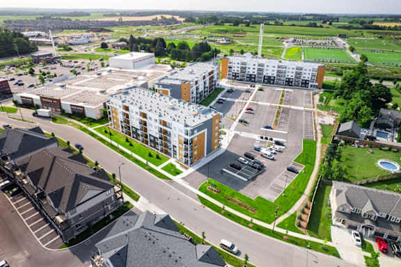 A large building complex with a parking lot in front.