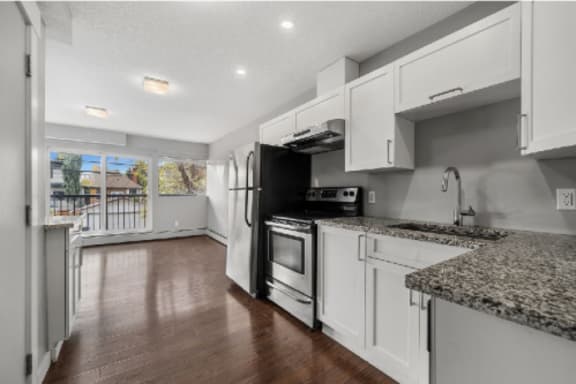 a kitchen with white cabinets and stainless steel appliances