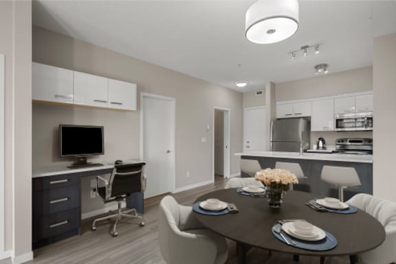 a dining room and kitchen with a table and chairs