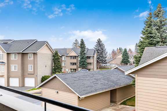 A row of houses with a clear blue sky above them at Graymayre Crossing Apartments, Spokane, WA, 99208