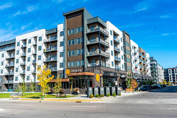 A street view of a building named Fenwick Podium. at Podium Apartments, Calgary, AB