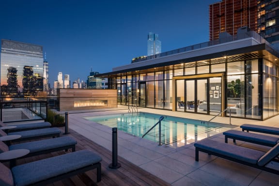 the pool on the rooftop of a building in the city at night at The Lively, Jersey City New Jersey