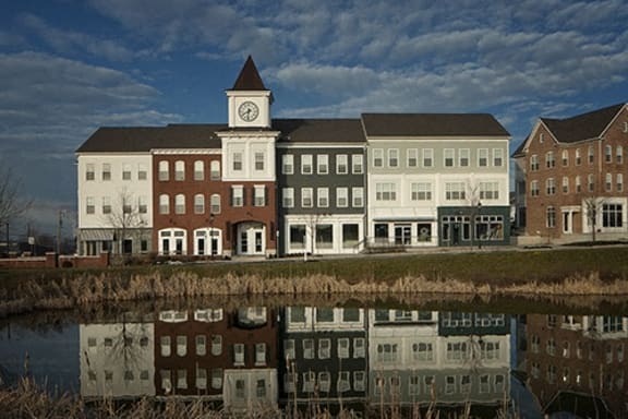 a building with a clock tower next to a body of water