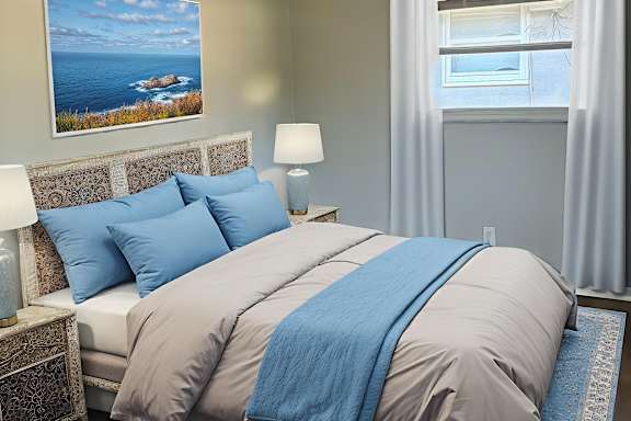 A bedroom with a bed, a bench, and a painting on the wall.