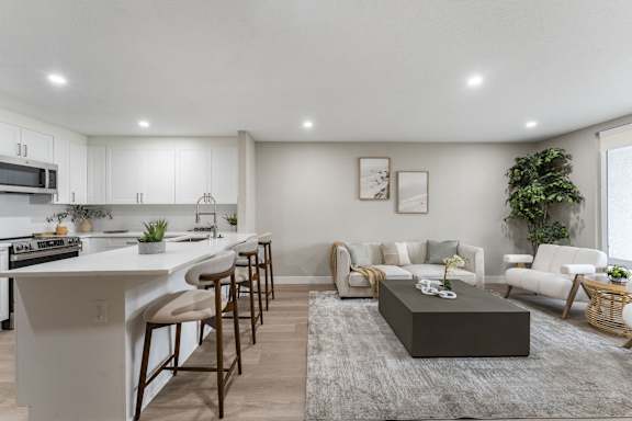 A modern kitchen with white cabinets and a large island.at Tamarack Sands Apartment Homes, Carlsbad, CA, 92008
