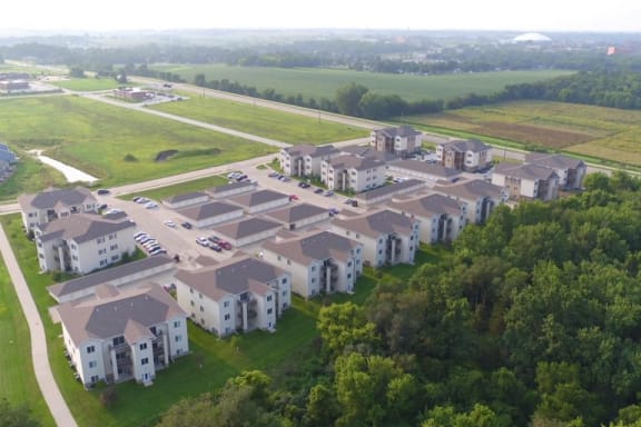 an aerial view of an apartment complex next to a highway