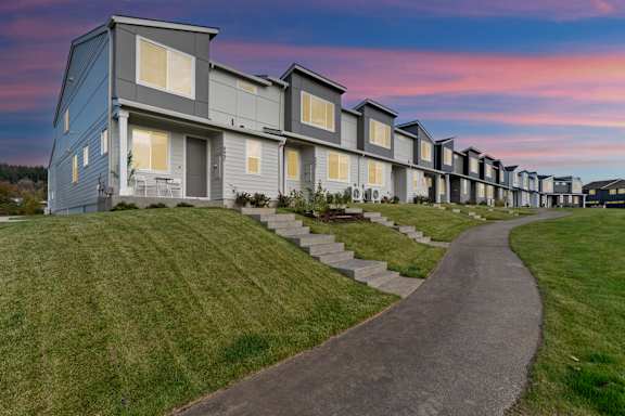 Building with balconies and a sidewalk at Thrive at Green Mountain, Camas