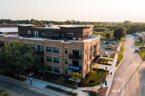 an aerial view of a brick building on a city street