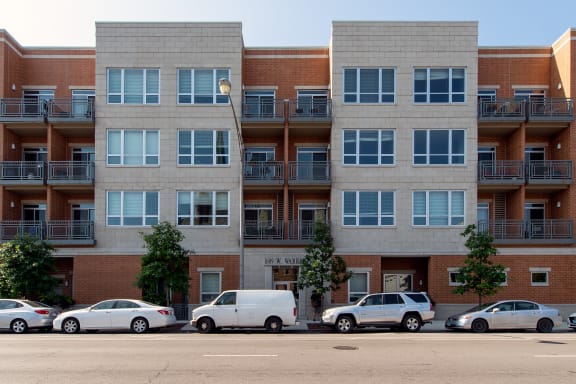 an apartment building with cars parked in front of it
