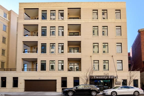 a large tan building with cars parked in front of it