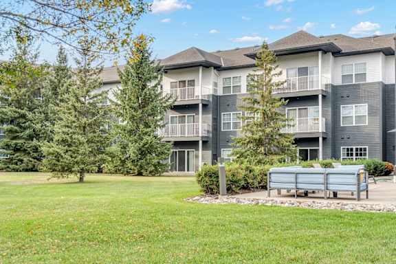 A large grassy area in front of apartment buildings.