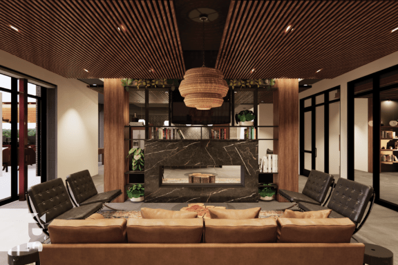 a living room with a couch and chairs and a fireplace at Ardor on the Bluffs South Loop Residences Apartments, Bloomington
