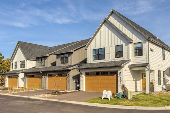 the front of a house with two garage doors