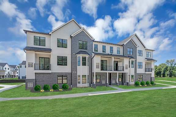 an exterior view of a large apartment building with a green lawn at The Franklin Marlboro Apartments, New Jersey