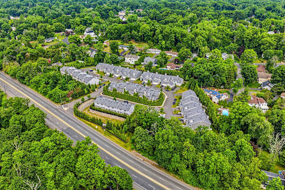 A bird's eye view of a residential area with houses and a road.