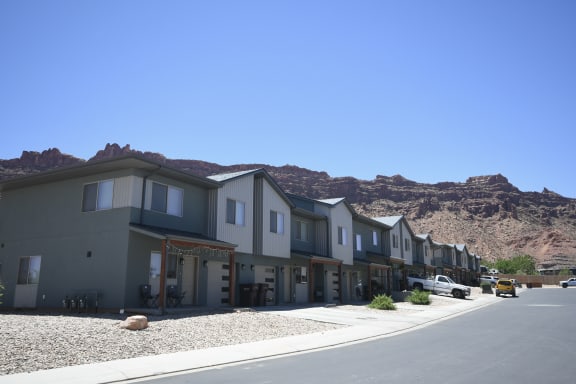 a row of houses with mountains in the background