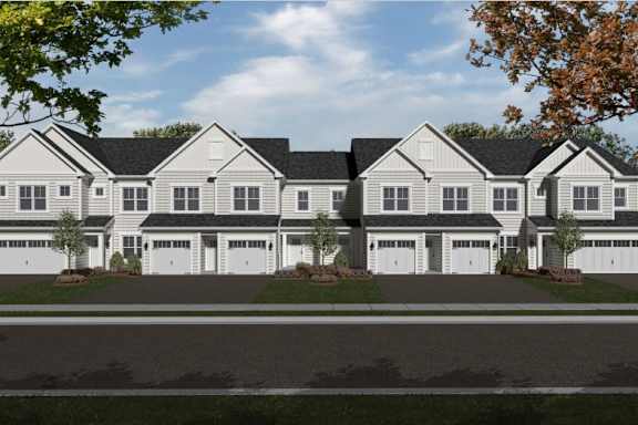 A row of houses with garages in front.