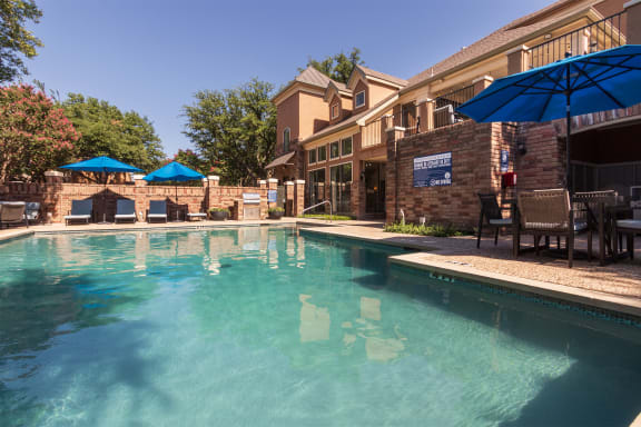This is a photo of the pool area at The Brownstones Townhome Apartments in Dallas, TX.