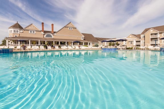 a large swimming pool with a building in the background