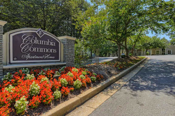 A sign for Columbia Commons subdivision is in front of a street.