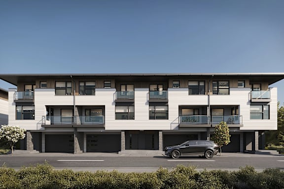 A modern building with a car parked in front.