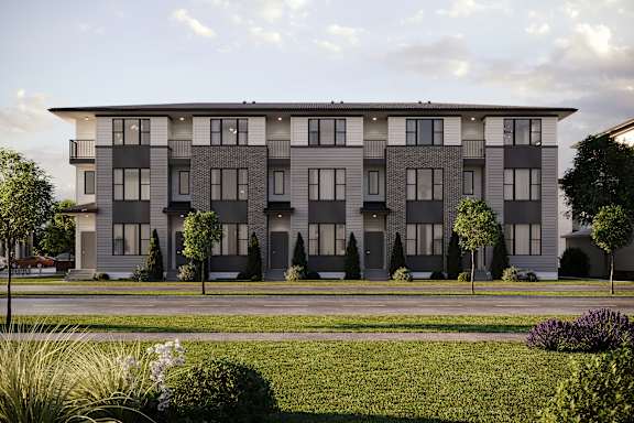 A modern apartment building with a grassy front yard.