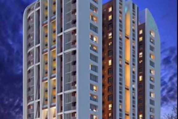 A modern white building with a lot of windows and balconies.