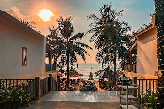 A sunset view from a balcony overlooking the ocean.
