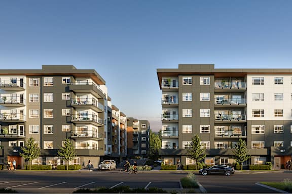 Two modern apartment buildings with balconies and multiple windows.