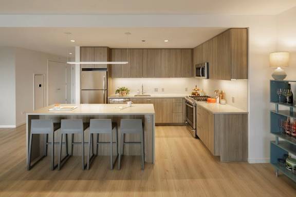 A modern kitchen with a dining table and chairs.