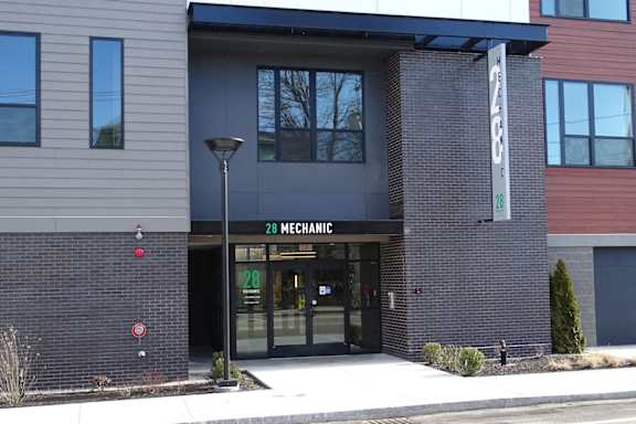 The front of a building with a sign that reads "28 Mechanic".