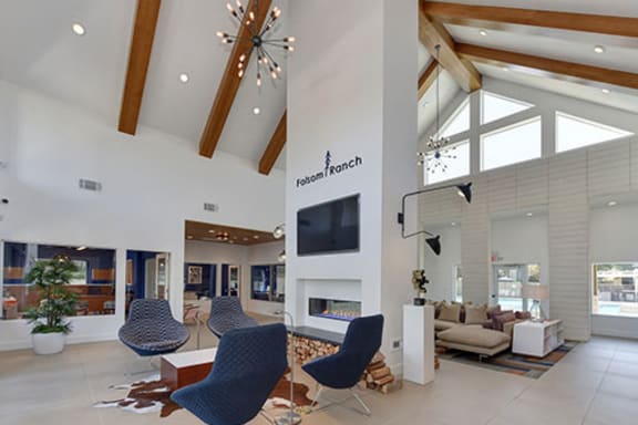 Community Leasing Office Lounge Area with Hardwood Inspired Floor, Blue Chairs and Mounted Flat Screen TV,at Folsom Ranch, California, 95630