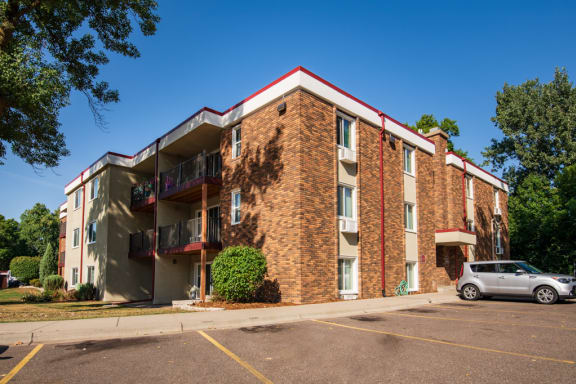 an apartment building with a car parked outside of it