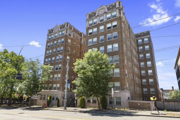 a tall brick building on a city street