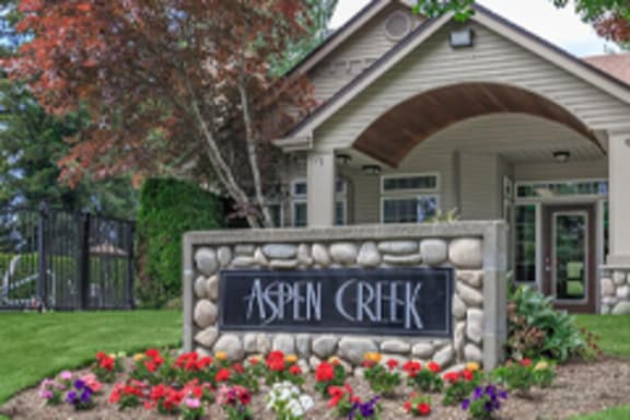 a building with a sign that reads aspen creek