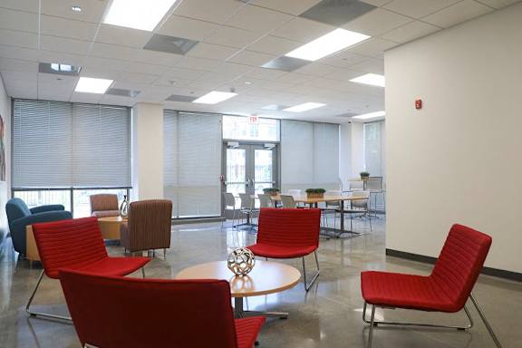 a large room with red chairs and tables