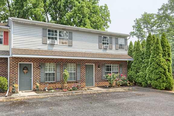 a view of the front of the house with a parking lot in front of it